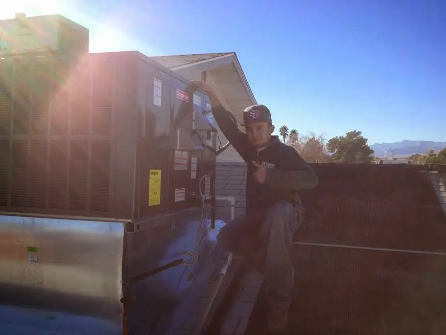 HVAC technician performing HVAC Inspection on a rooftop unit in Huntington Park